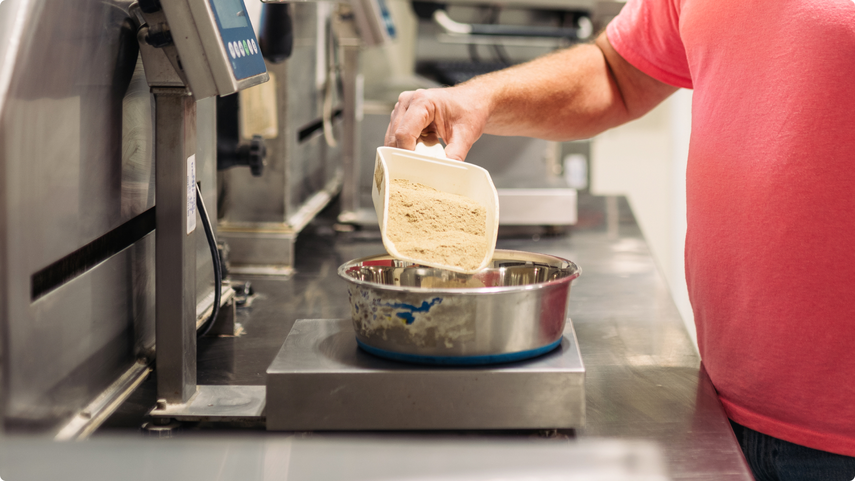 Hill's Pet Global Pet Nutrition Center researcher measuring the pet food on a scale